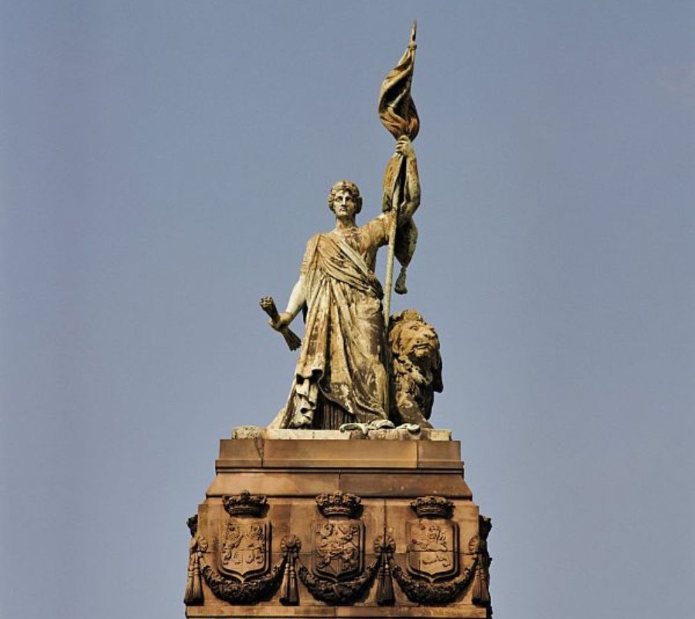 Beeld van de Nederlandse maagd bovenop het monument 1813 op het plein 1813 in Den Haag. (foto: Wikimedia)